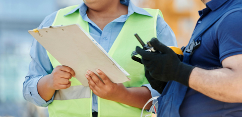 Two people on a construction site.